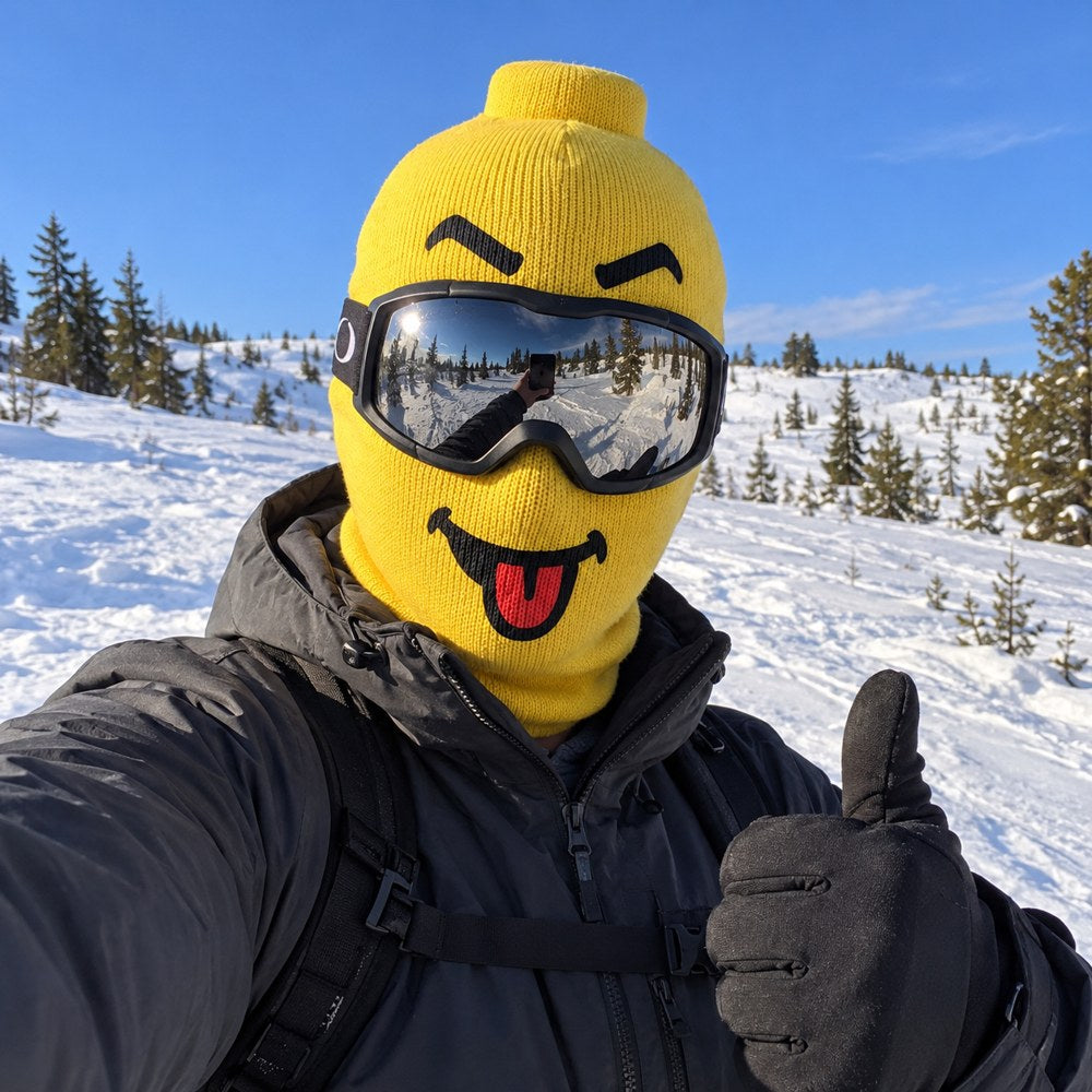 Skier in a yellow Originals mask giving a thumbs up